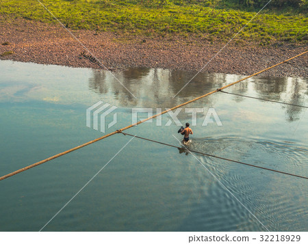 fisherman hunt fish by gun in Kwai river fisherman hunt fish by gun in Kwai river 32218929