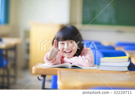 happy kid thumb up with book in class happy kid thumb up with book in class 32220711