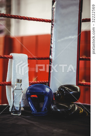 Boxing gloves, headgear, water bottle and a towel in boxing ring 32222569