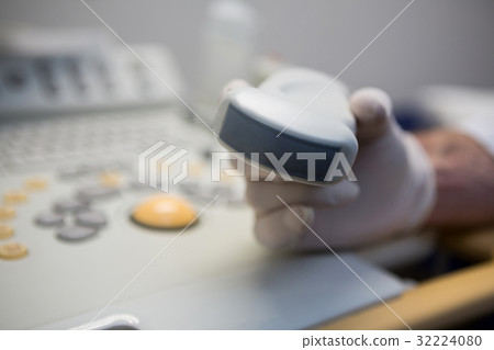 Doctors using sonography machine Doctors using sonography machine 32224080