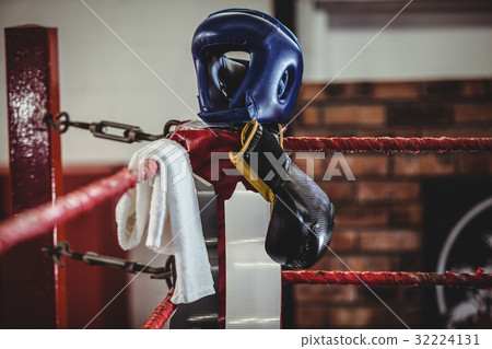Boxing gloves, headgear and a towel kept on boxing ring 32224131