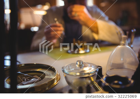 Horologist repairing a watch Horologist repairing a watch 32225069