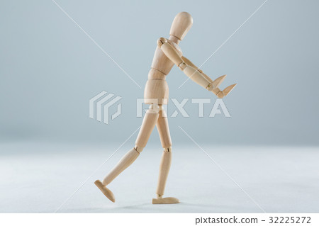 Wooden figurine pretending to push an invisible object 32225272