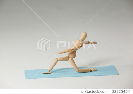 Wooden figurine exercising on exercise mat Wooden figurine exercising on exercise mat 32225404
