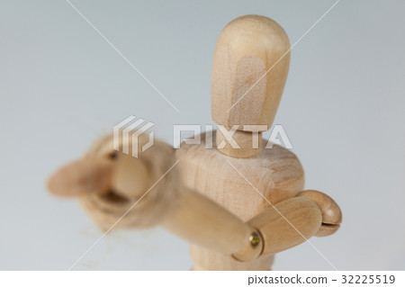 Hands of wooden figurine tied with a rope Hands of wooden figurine tied with a rope 32225519