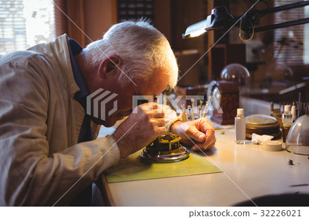 Horologist repairing a watch 32226021