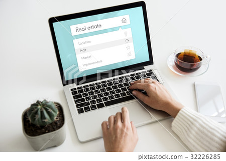 People using digital laptop about real estate word 32226285