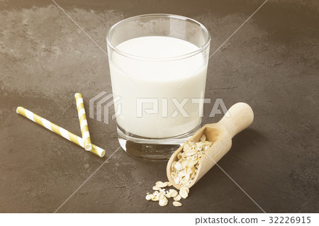 Vegan oat milk in glass on a dark background 32226915
