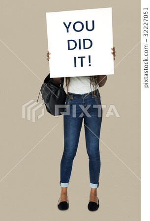 African girl holding you did it banner cover her face 32227051