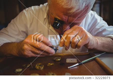 Horologist repairing a watch Horologist repairing a watch 32228073