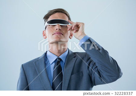 Businessman using virtual reality glasses against white background 32228337
