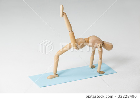 Wooden figurine exercising on exercise mat Wooden figurine exercising on exercise mat 32228496
