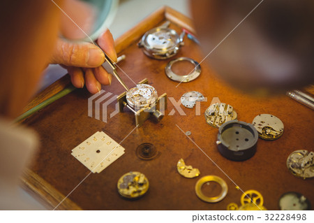 Horologist repairing a watch Horologist repairing a watch 32228498