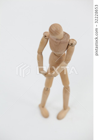 Wooden figurine standing with hands on knee Wooden figurine standing with hands on knee 32228653
