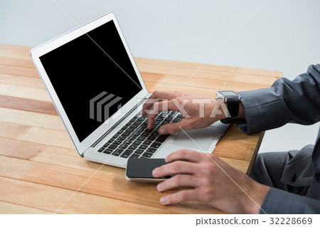 Businessman using laptop 32228669