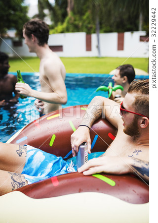 Group of diverse friends enjoying summer time by the pool Group of diverse friends enjoying summer time by the pool 32229442