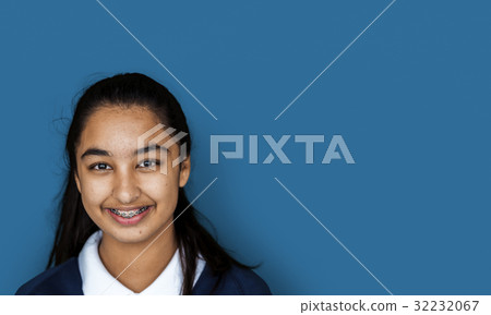 Portrait studio shoot of schoolgirl in uniform with smiling 32232067