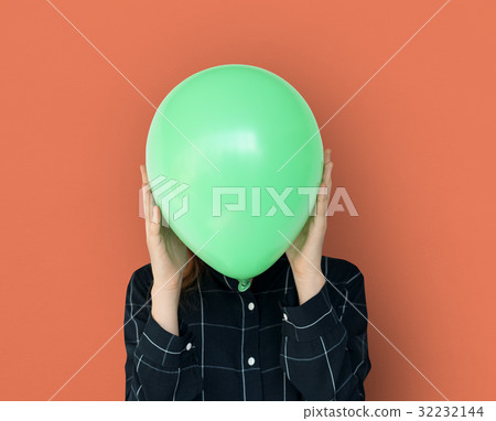 Woman close up holding balloon and posing for photoshoot Woman close up holding balloon and posing for photoshoot 32232144