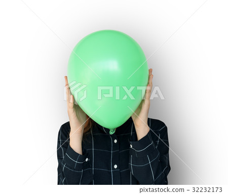 Woman close up holding balloon and posing for photoshoot Woman close up holding balloon and posing for photoshoot 32232173