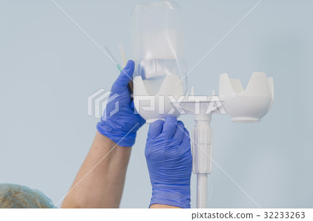 Doctor's hands and infusion drip in hospital on 32233263