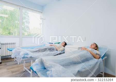 Female patient sleeping in medical bed at the Female patient sleeping in medical bed at the 32233264