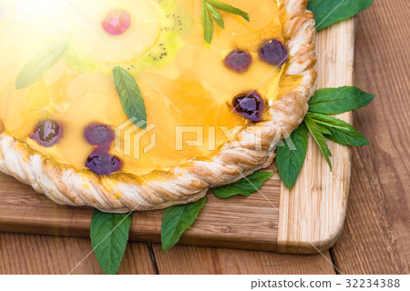 Fruit pizza with pineapple, orange, kiwi, cherry 32234388