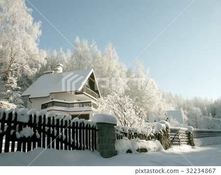 Cottage surrounded by winter scenery 32234867