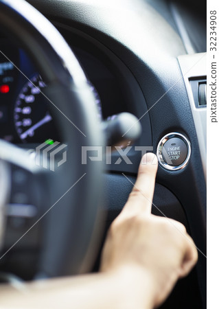 finger pressing the Engine start stop button 32234908