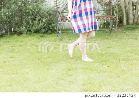 A young lady with a flower pot in the garden 32236427