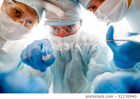 Team of surgeons at work Team of surgeons at work 32236940