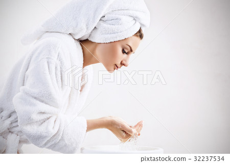 Young woman washing face with clean water. Young woman washing face with clean water. 32237534