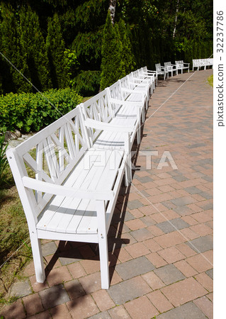 White Wooden Benches in the park, summer day 32237786