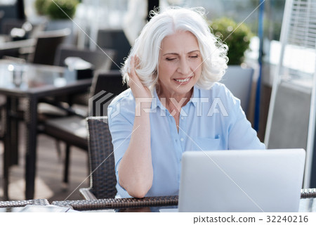 Concentrated female looking at screen of her Concentrated female looking at screen of her 32240216