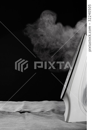 Steaming iron on a denim, ironing clothes 32240505