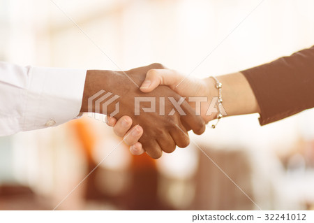 People at work: man and woman hand shaking at a 32241012