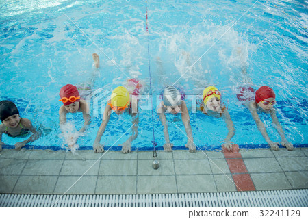 Instructor and group of children doing exercises 32241129