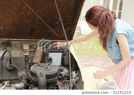 Women maintaining cars Women maintaining cars 32241219
