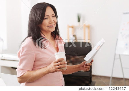 Smiling pregnant woman standing in the office Smiling pregnant woman standing in the office 32243617