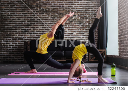 Young female adult doing crescent lunge pose and Young female adult doing crescent lunge pose and 32243800