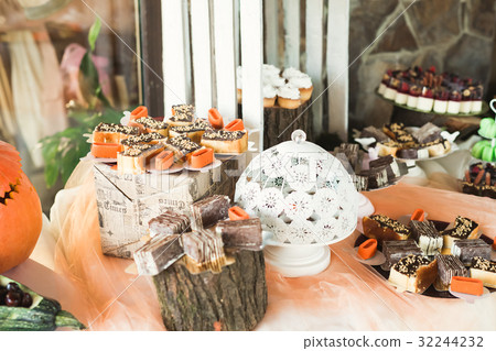 Delicious and tasty dessert table with cupcakes Delicious and tasty dessert table with cupcakes 32244232