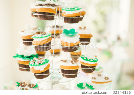 Delicious and tasty dessert table with cupcakes Delicious and tasty dessert table with cupcakes 32244336