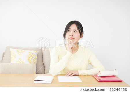 A young woman studying at home A young woman studying at home 32244468