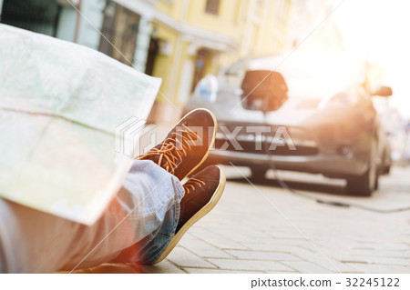 Male legs with map on them facing the car Male legs with map on them facing the car 32245122
