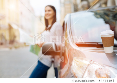 White coffee cup standing on the car hood White coffee cup standing on the car hood 32245461
