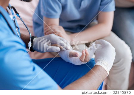 Close up of doctors hands that holding bandage Close up of doctors hands that holding bandage 32245870