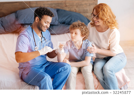 Positive delighted doctor treating his patient 32245877