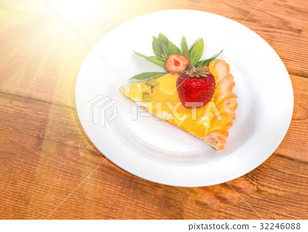 Slice of fruit pizza with strawberries and mint 32246088