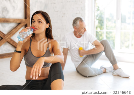 Relaxed charming woman drinking fresh water Relaxed charming woman drinking fresh water 32246648