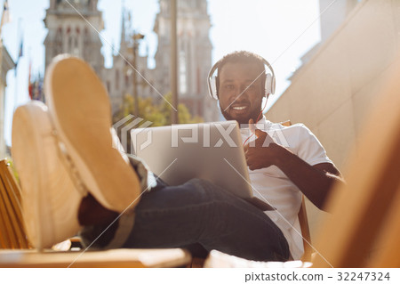 Relaxed cheerful man loving working outdoors Relaxed cheerful man loving working outdoors 32247324