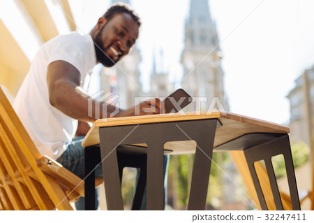 Lively young man using his phone Lively young man using his phone 32247411